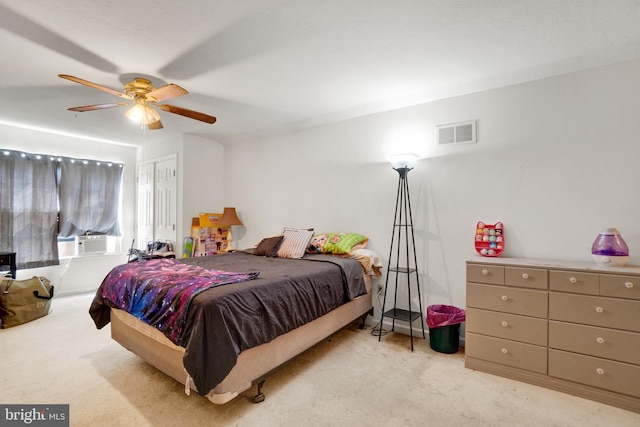 carpeted bedroom featuring cooling unit, a closet, and ceiling fan