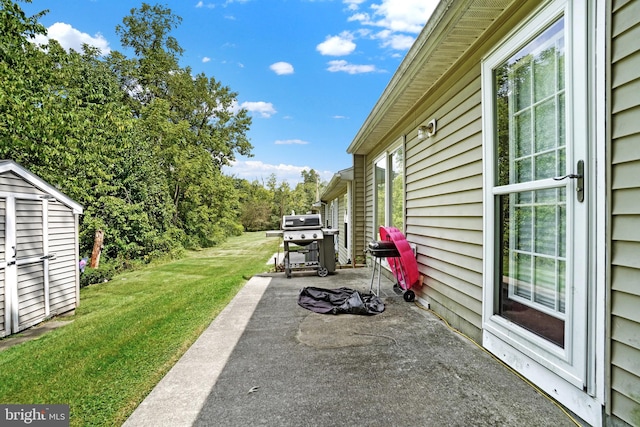 view of patio / terrace featuring grilling area and a shed