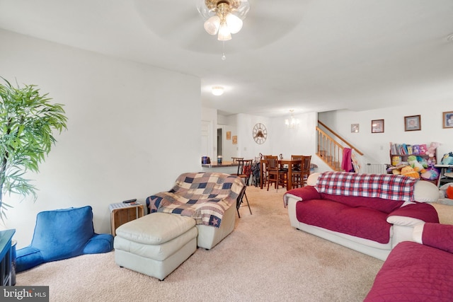 carpeted living room with ceiling fan