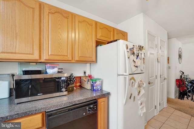 kitchen with white refrigerator, light brown cabinets, dishwasher, and light tile patterned floors