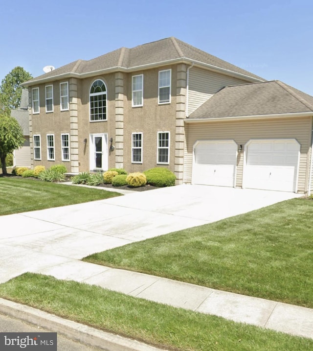 colonial inspired home with a garage and a front yard