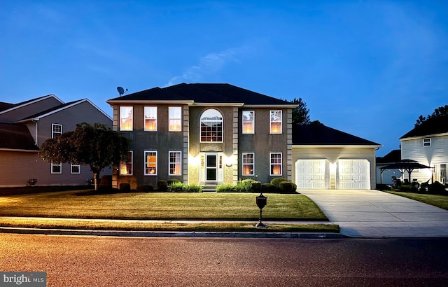 view of front of home with a front yard and a garage