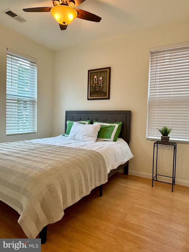 bedroom with light wood-type flooring and ceiling fan