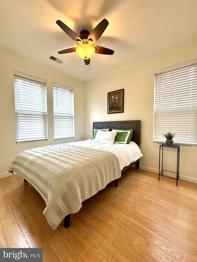 bedroom with light wood-type flooring and ceiling fan