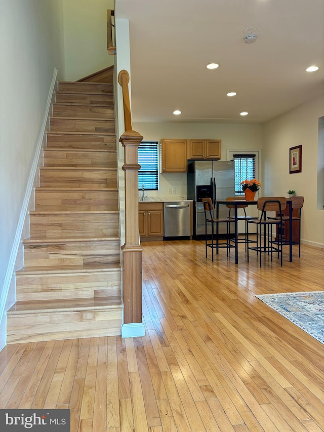 stairs featuring wood-type flooring