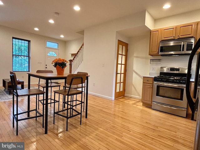 interior space with light brown cabinets, appliances with stainless steel finishes, and light hardwood / wood-style flooring