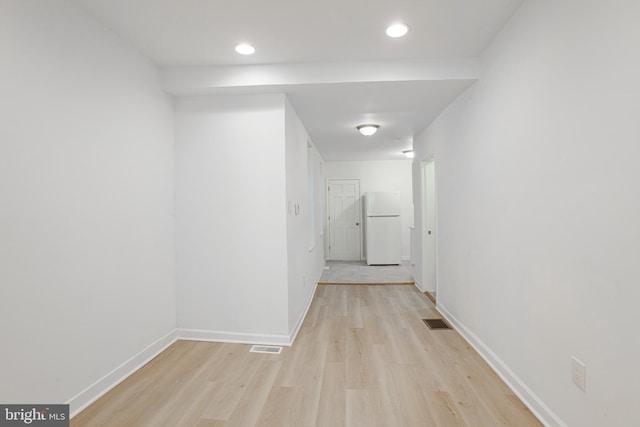 hallway with light hardwood / wood-style flooring