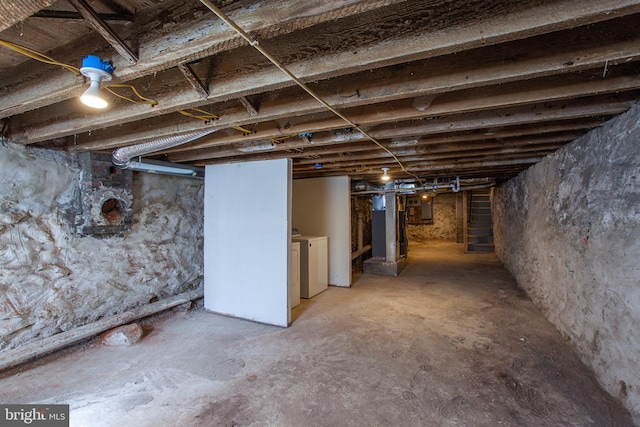 basement featuring electric panel and independent washer and dryer