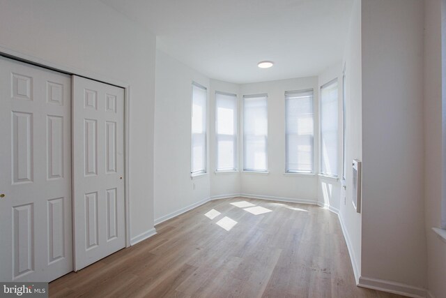 unfurnished bedroom featuring light hardwood / wood-style flooring and a closet