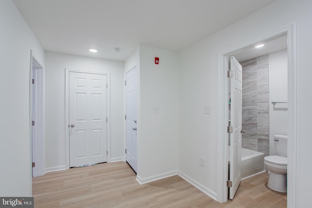 interior space with connected bathroom and light hardwood / wood-style flooring