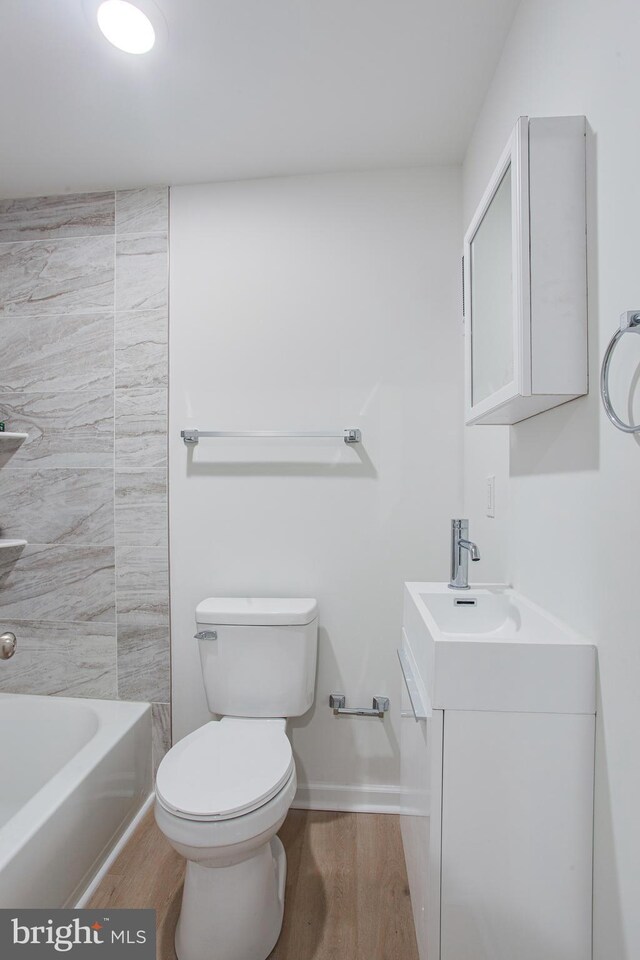 bathroom featuring vanity, toilet, and hardwood / wood-style floors