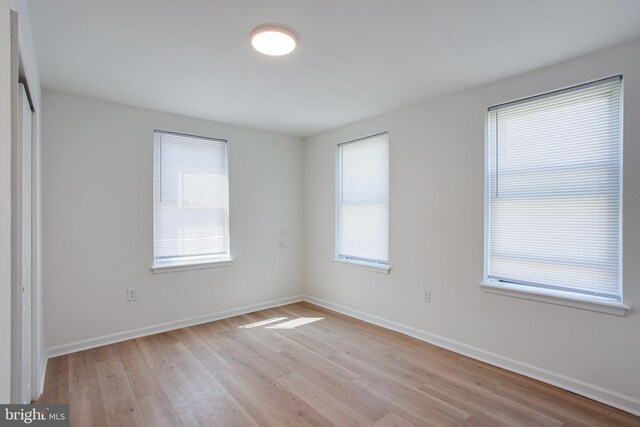 unfurnished room with light hardwood / wood-style flooring