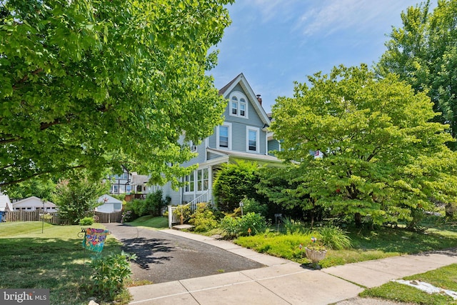 obstructed view of property featuring a front yard