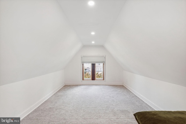 bonus room featuring lofted ceiling and light carpet