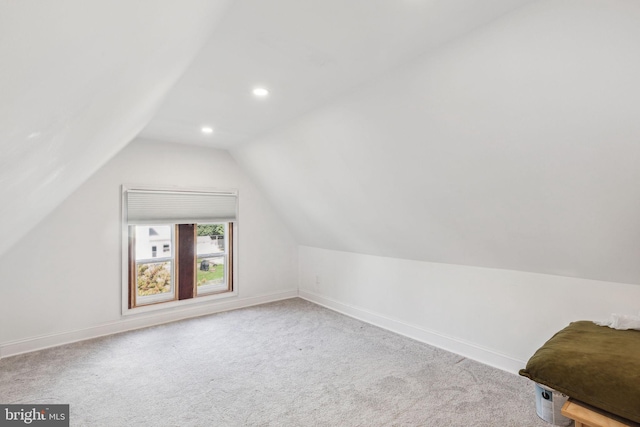 bonus room with light carpet and lofted ceiling