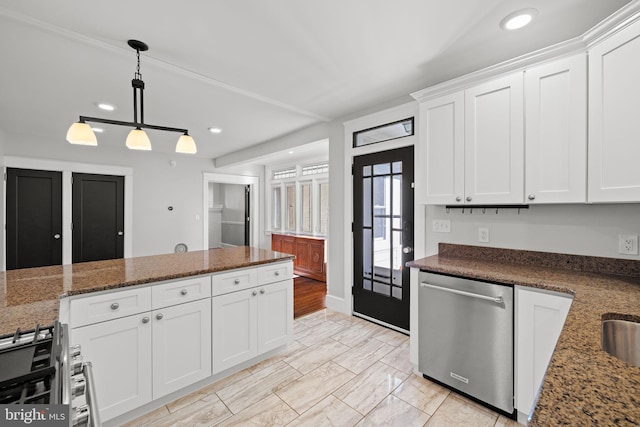 kitchen with dark stone countertops, appliances with stainless steel finishes, decorative light fixtures, and white cabinets