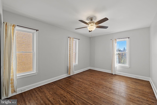 spare room featuring dark hardwood / wood-style flooring and ceiling fan