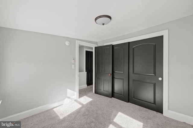 unfurnished bedroom featuring a closet and carpet floors