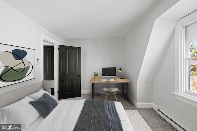 carpeted bedroom with vaulted ceiling, built in desk, and a baseboard heating unit