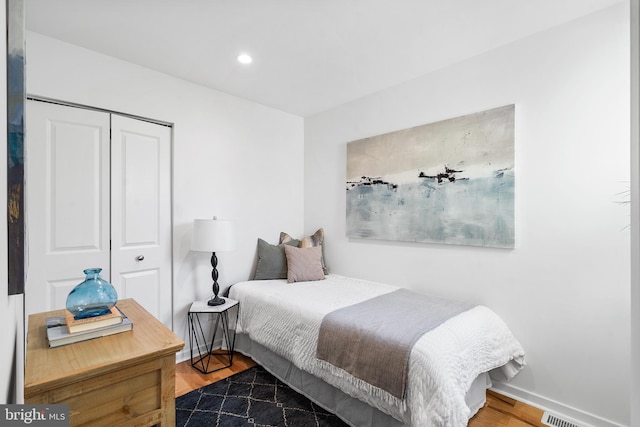 bedroom featuring a closet and dark hardwood / wood-style flooring