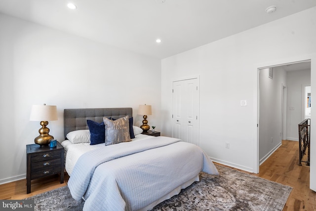 bedroom with wood-type flooring and a closet