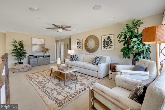 carpeted living room with ceiling fan