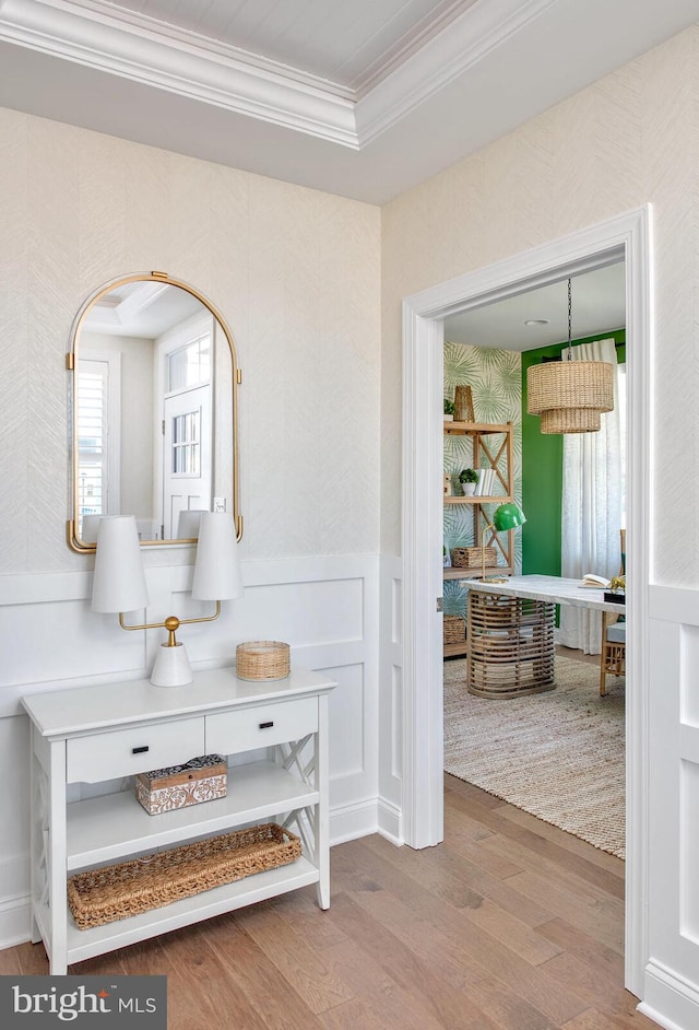 hall featuring wood-type flooring and ornamental molding