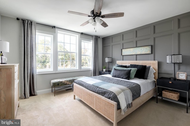 bedroom with ceiling fan and light carpet