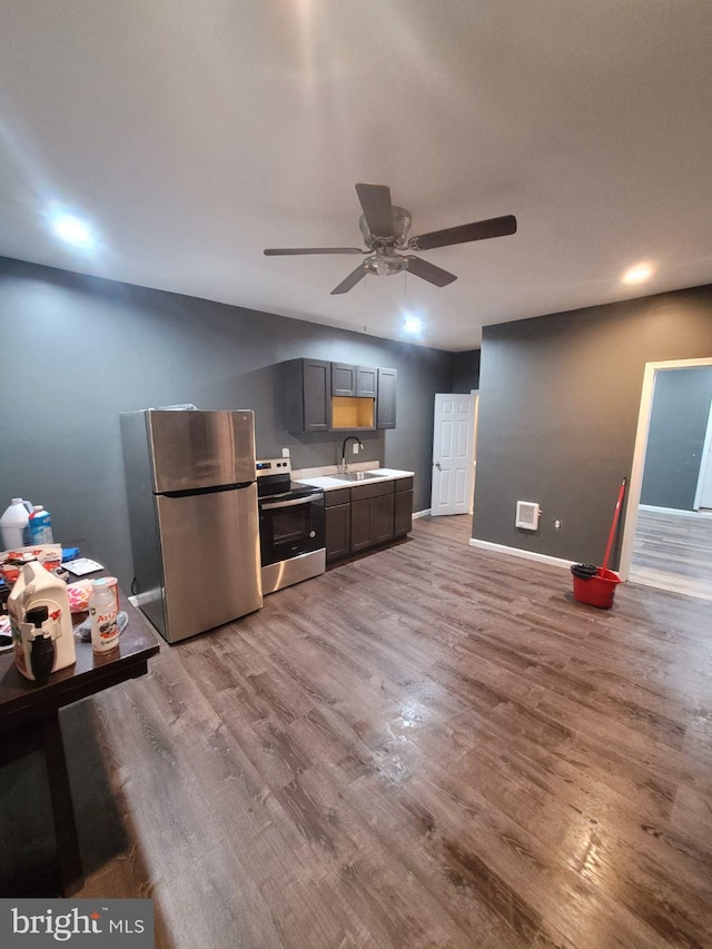 kitchen with ceiling fan, stainless steel appliances, wood-type flooring, and sink