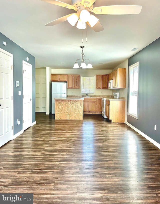 kitchen with ceiling fan with notable chandelier, electric stove, pendant lighting, and dark hardwood / wood-style flooring