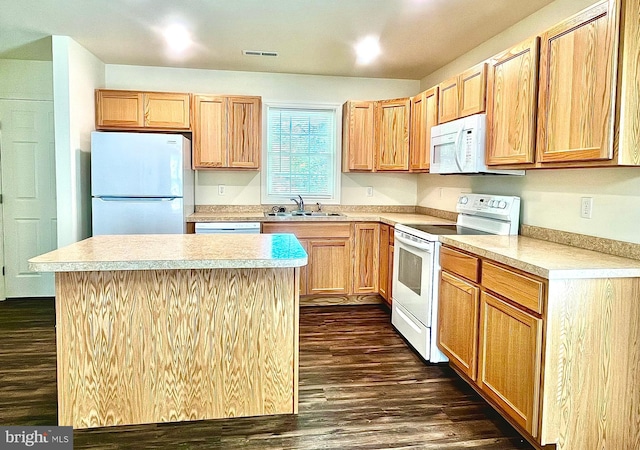 kitchen with white appliances, a center island, dark hardwood / wood-style floors, and sink