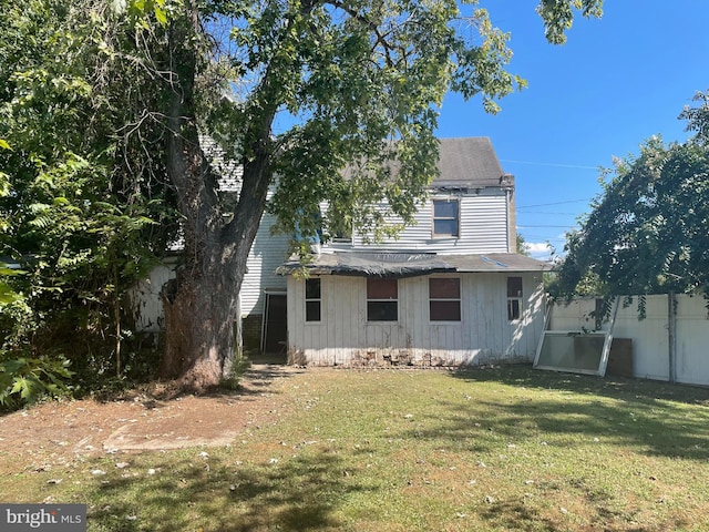 back of property featuring a lawn