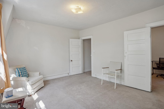 sitting room featuring light colored carpet