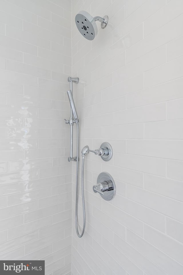 interior details featuring tiled shower