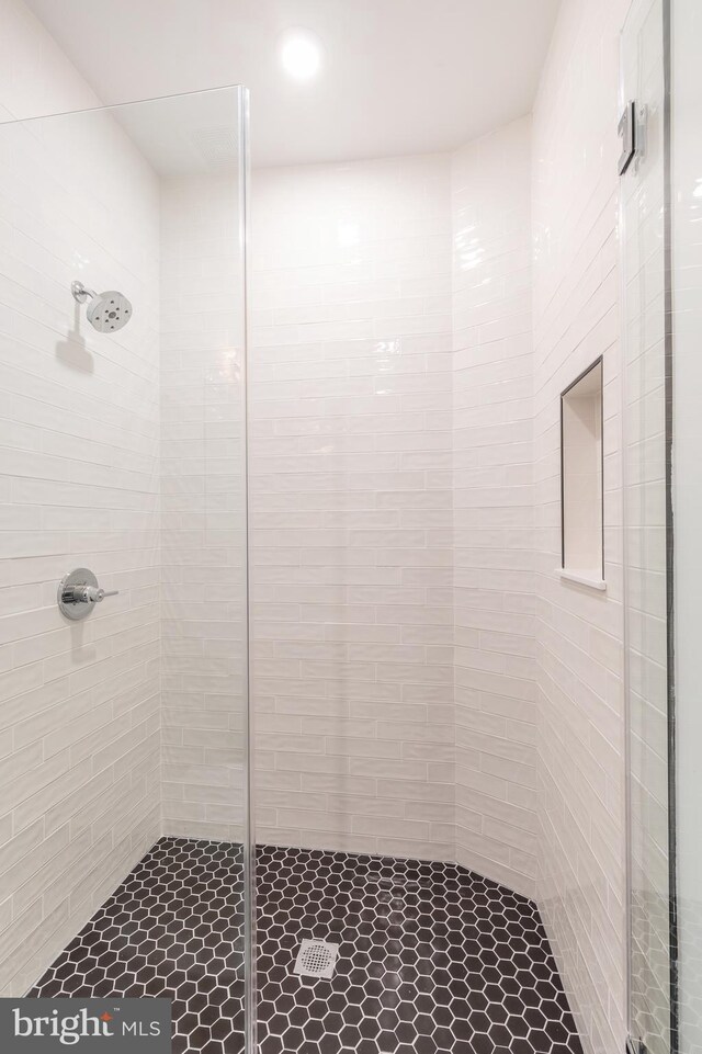 bathroom with tiled shower