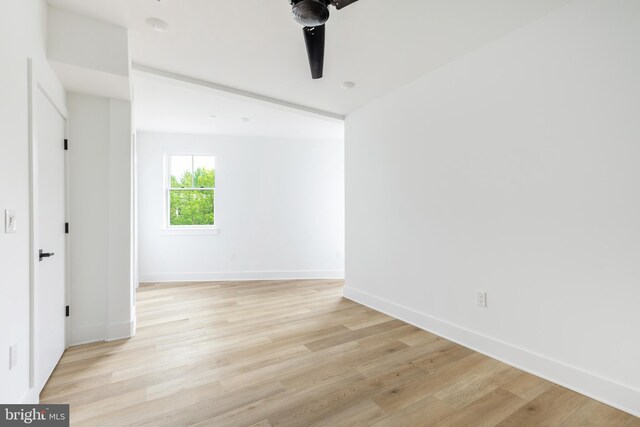 spare room featuring light wood-type flooring and ceiling fan