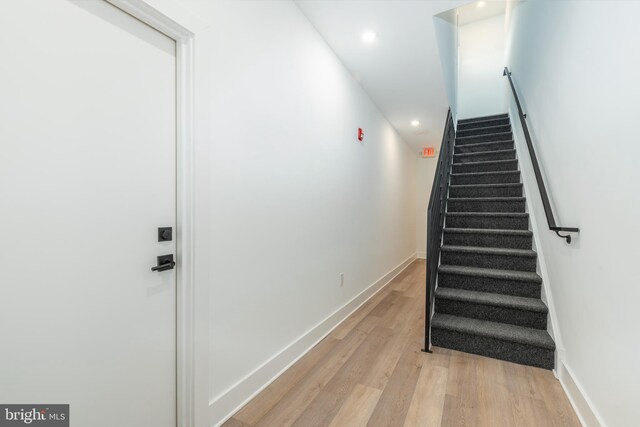 stairs with hardwood / wood-style flooring