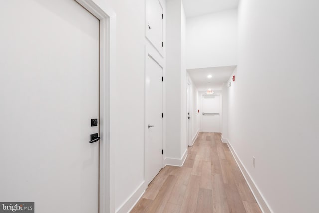 hallway with light hardwood / wood-style floors