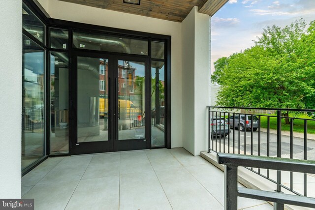 view of exterior entry featuring a balcony