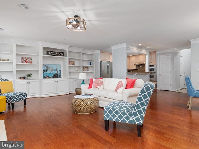 living room featuring wood-type flooring and crown molding