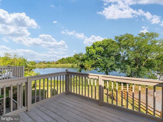 wooden terrace featuring a water view