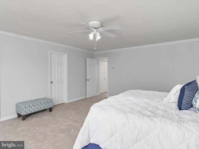 carpeted bedroom with ceiling fan and ornamental molding