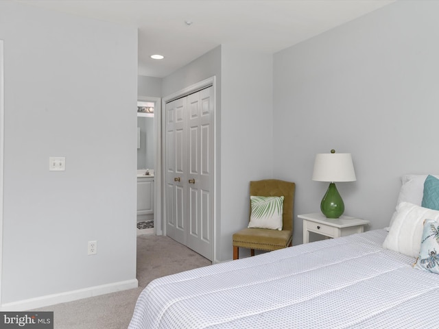 bedroom featuring light colored carpet and a closet