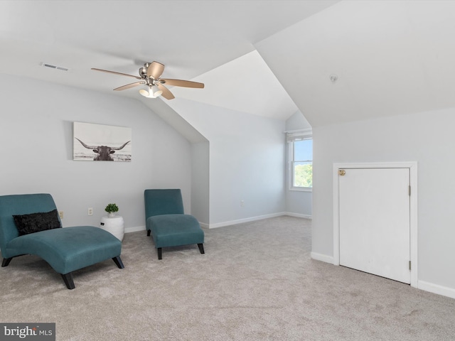 living area featuring light carpet, ceiling fan, and lofted ceiling