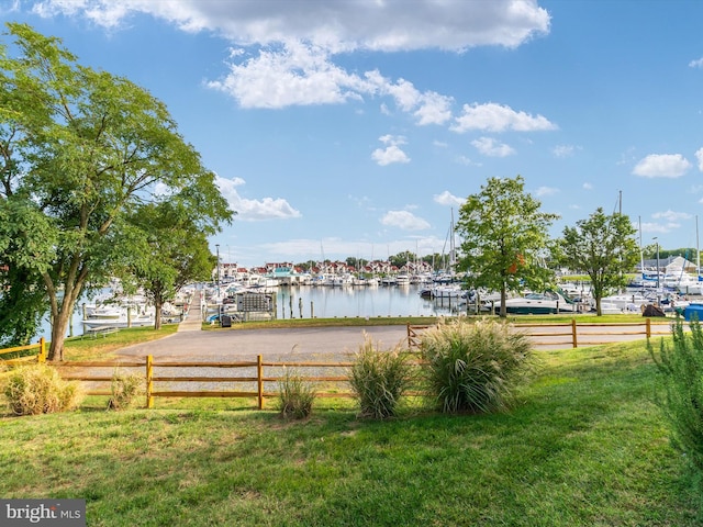 view of home's community featuring a yard and a water view