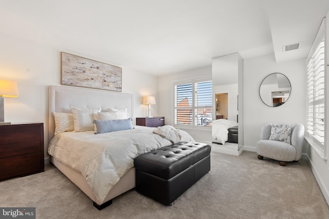 carpeted bedroom featuring visible vents and baseboards