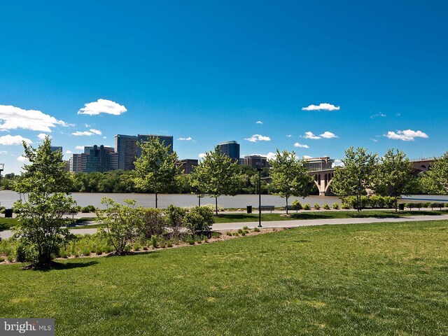 view of yard featuring a city view and a water view