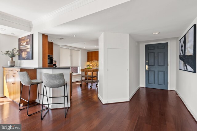 entrance foyer featuring visible vents, baseboards, ornamental molding, recessed lighting, and dark wood-style floors