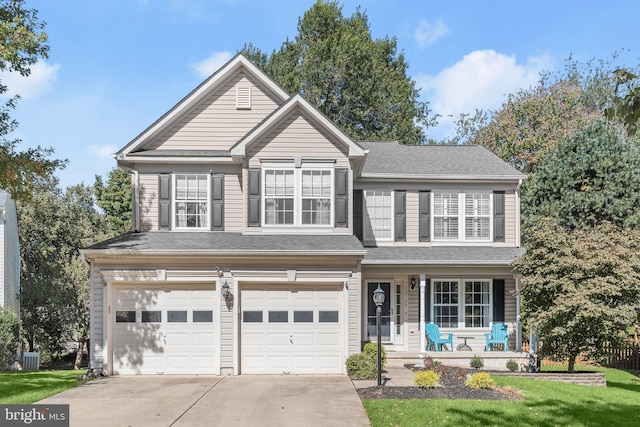 view of front property with a porch and a garage