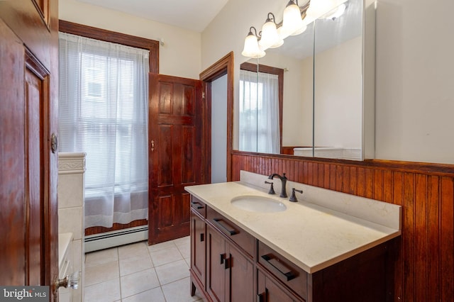 bathroom with tile patterned floors, a baseboard heating unit, wood walls, and vanity